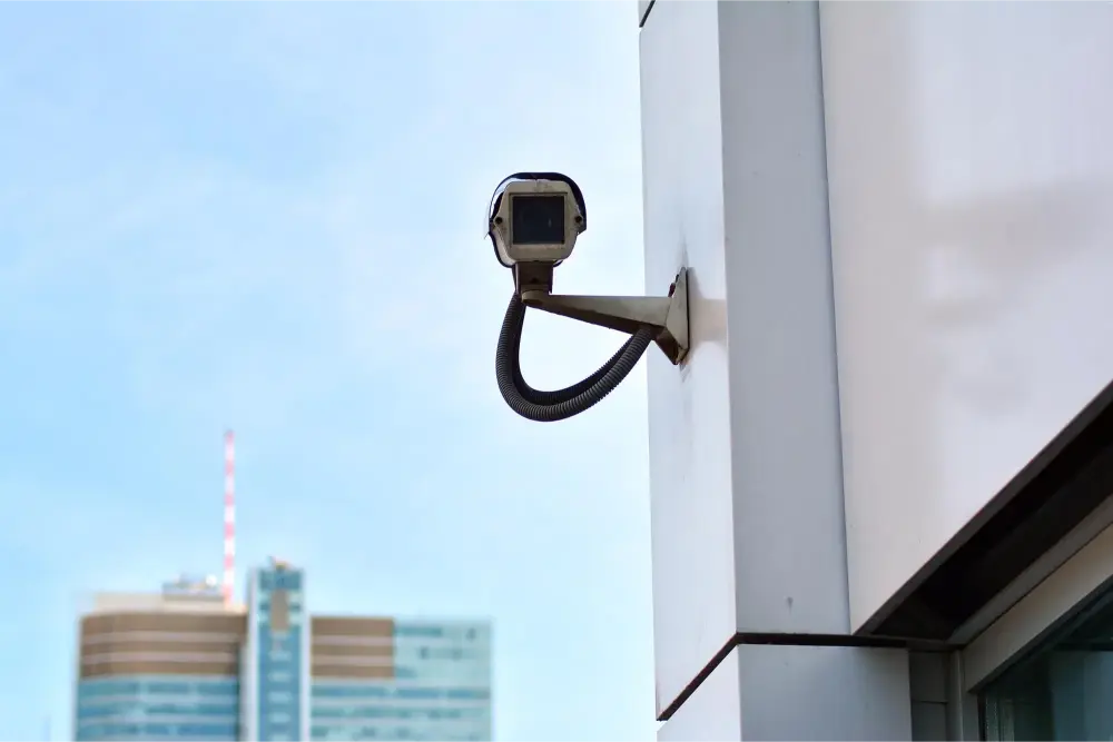 Certified, insured AFTECHS technician completing a security camera installation for business — 4K IP bullet camera mounted outdoors